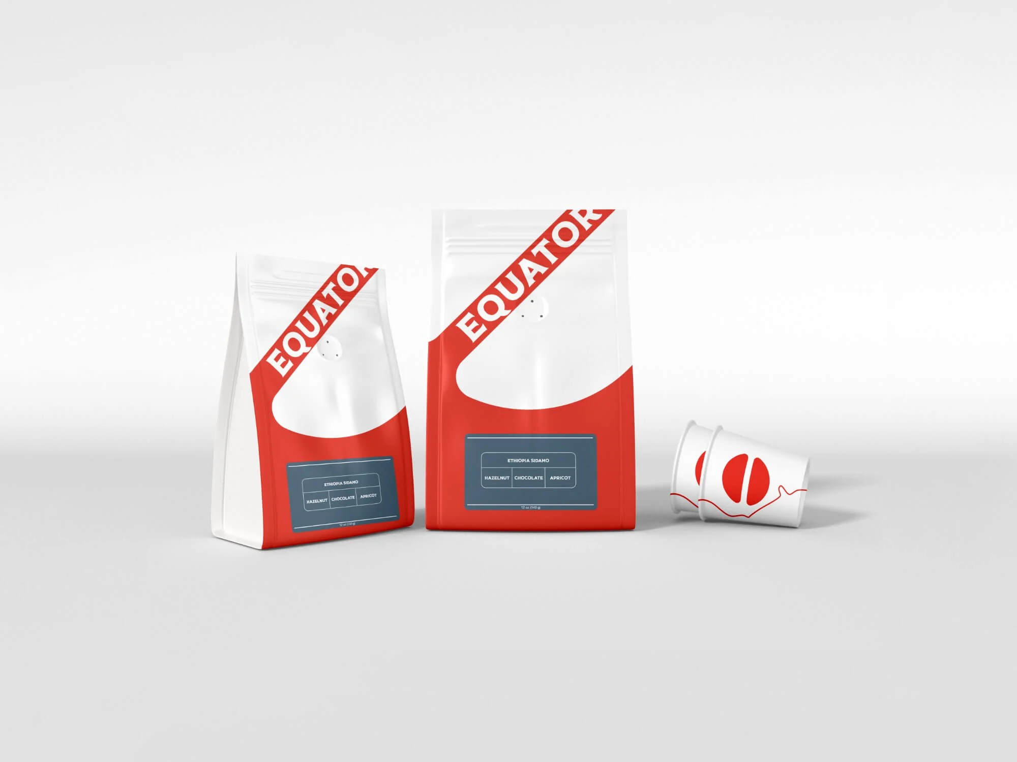 Equator Coffees whole bean coffee bags — two sizes in red and white with the Equator wordmark, alongside a branded paper cup